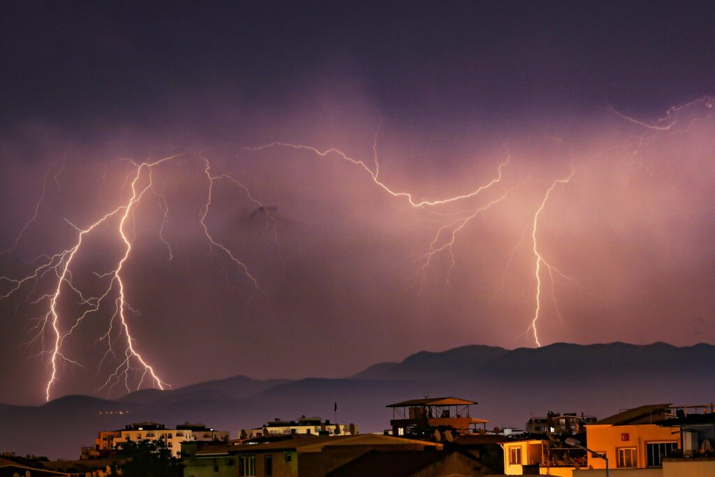 Striking image of a thunderstorm over Bursa, Türkiye, with vivid lightning illuminating the night sky.